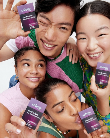 Friends holding Solves Strips Electrolyte packs